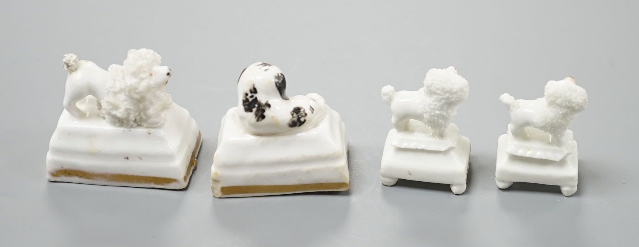 Four Staffordshire porcelain toy models of poodles and a King Charles spaniel puppy, c.1835-50, tallest 3.5 cm, Cf. Dennis G.Rice Dogs in English porcelain, colour plate 154., Provenance: Dennis G.Rice collection